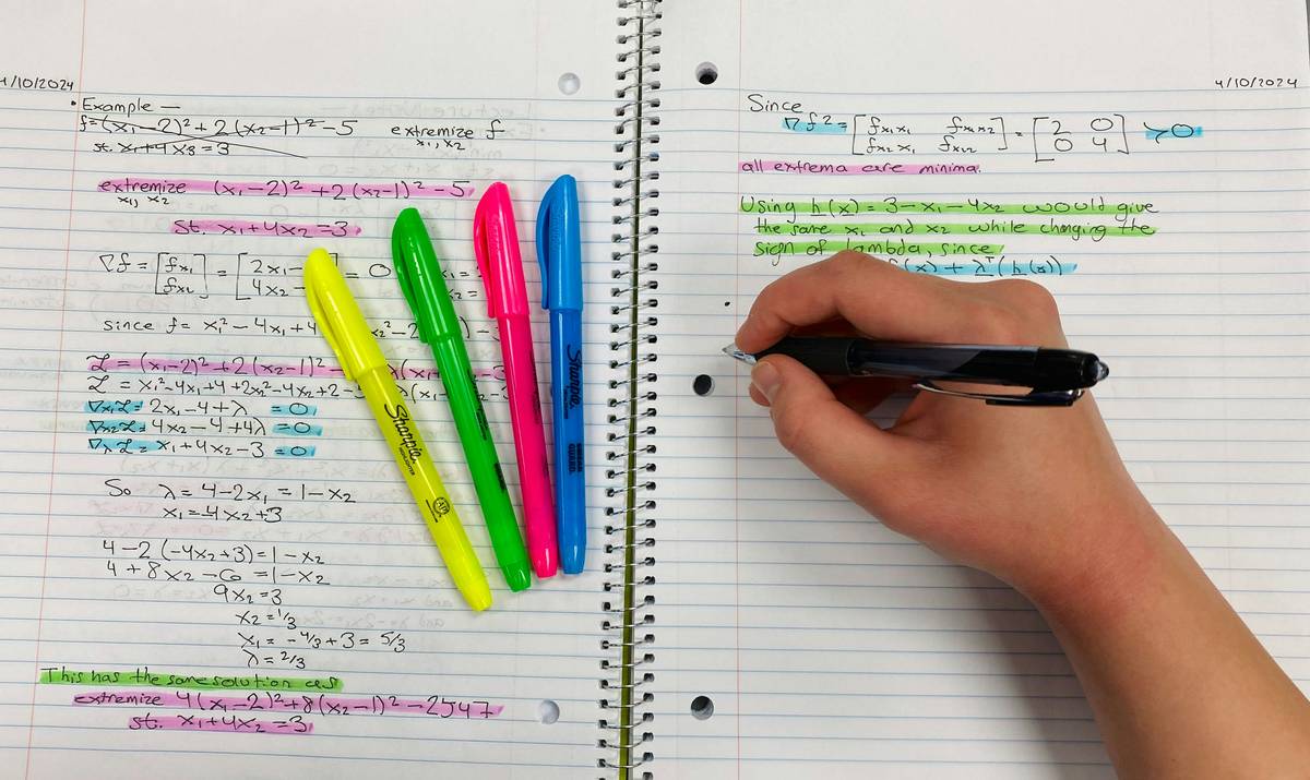 Student analyzing LSAT logical reasoning questions with guide reasoning prep notes