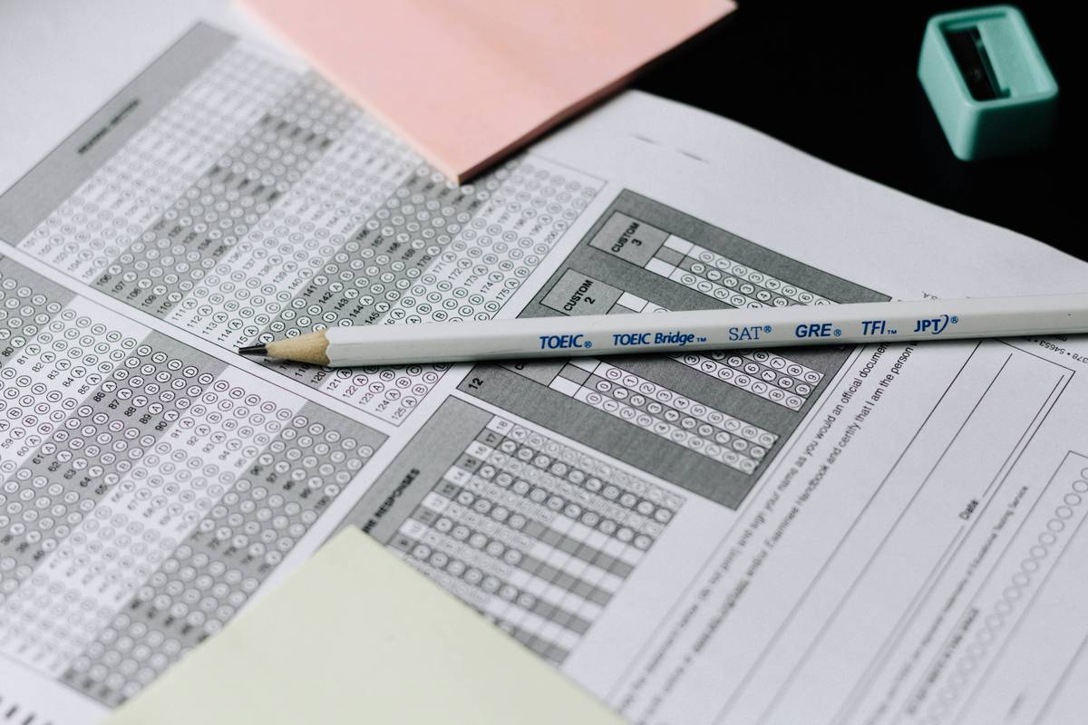 Student analyzing LSAT logical reasoning question with strategies reasoning prep notes on desk