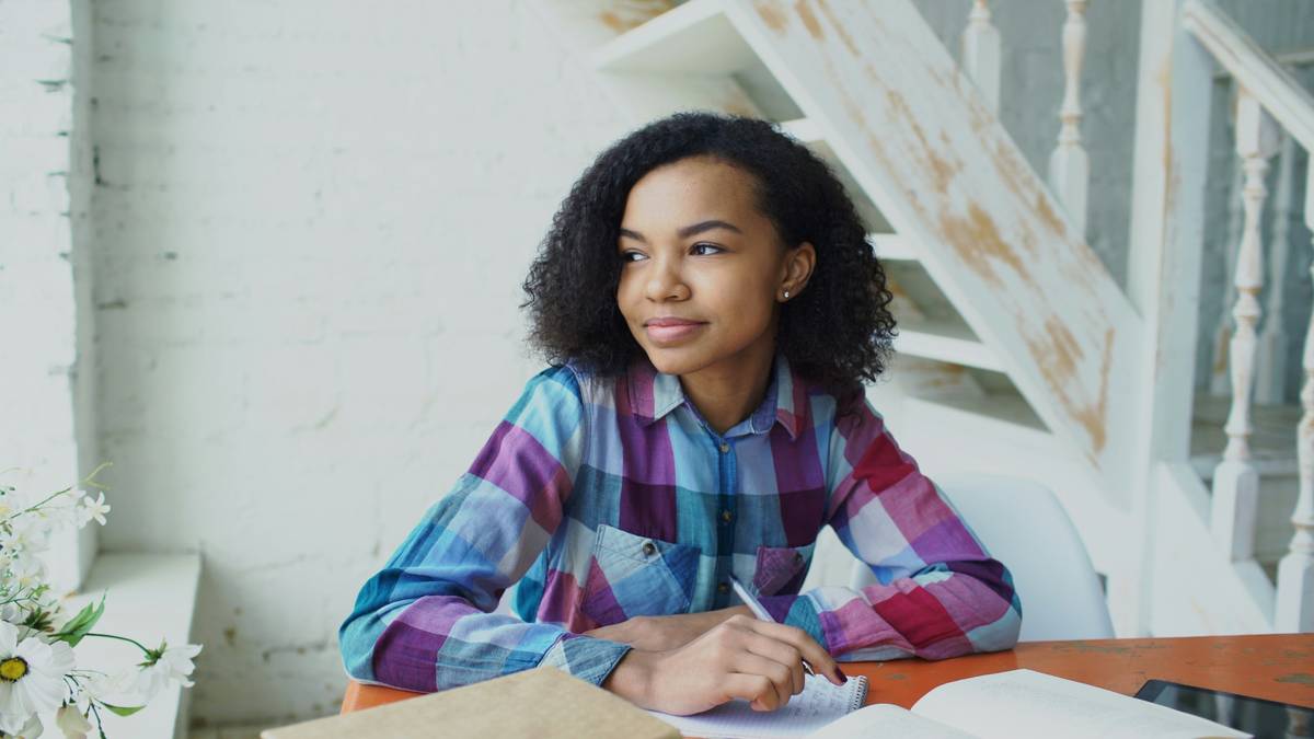 Student analyzing LSAT logical reasoning questions with plan reasoning prep notes on desk
